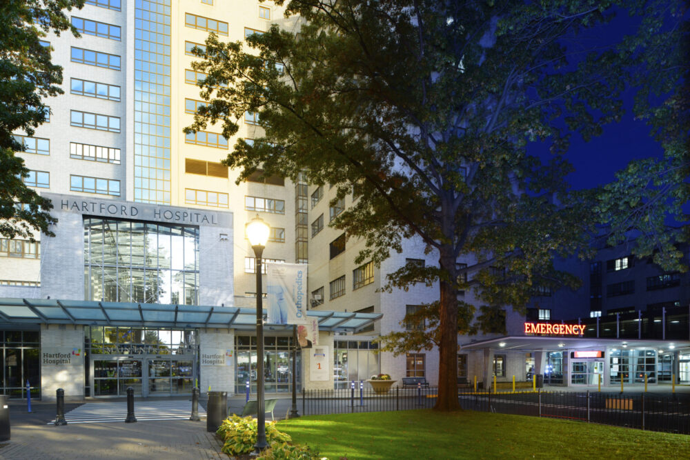 Exterior of a Hartford Hospital's main entrance in transition from day through afternoon into night.